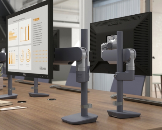 Image of a dual-arm monitor arm on a desk