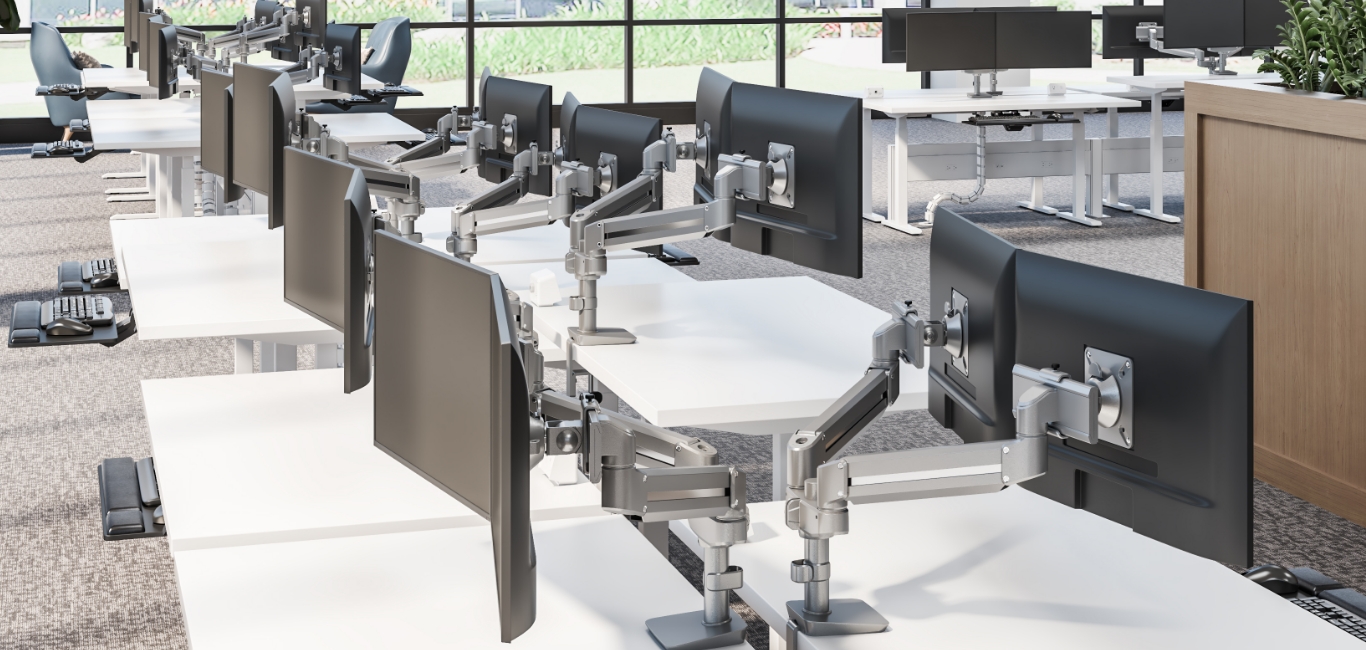 Image of a dual monitor arm attached to a desk
