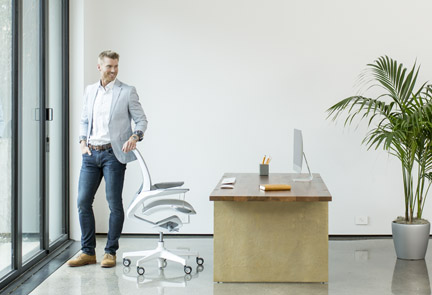 View of a man standing at his desk