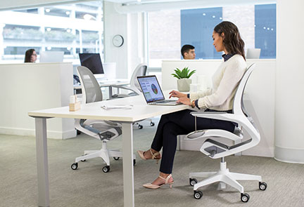 Woman sitting at desk working on laptop