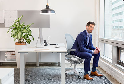 Man in an office staring out of the window