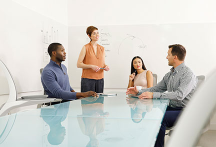 4 people in a conference room discussing something