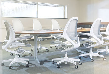 An empty conference room with white chairs