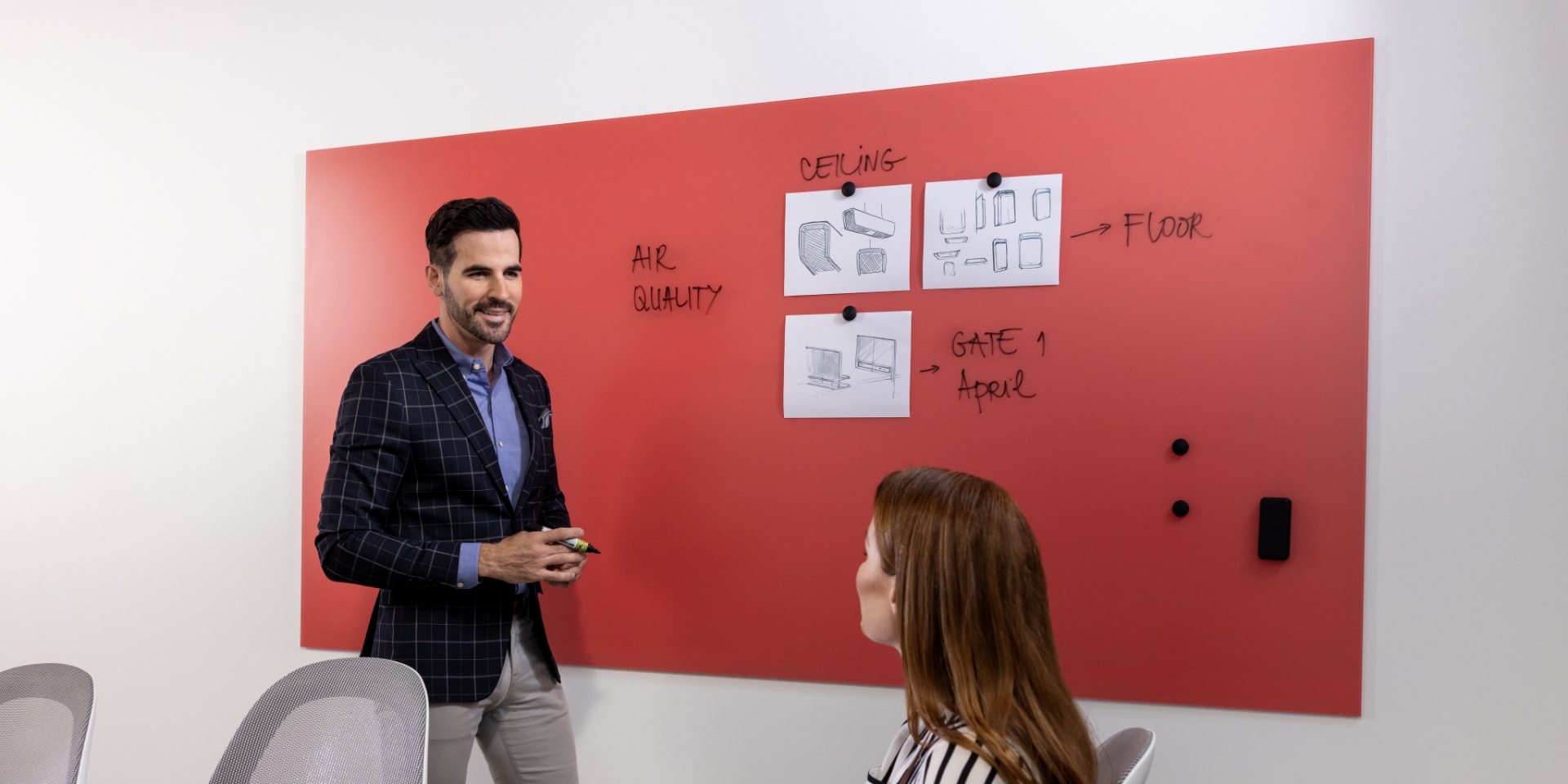 Image of two people looking at a monitor on a desk