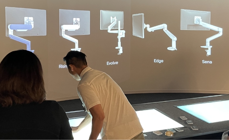 Man showing Monitor Arms on the Portray System