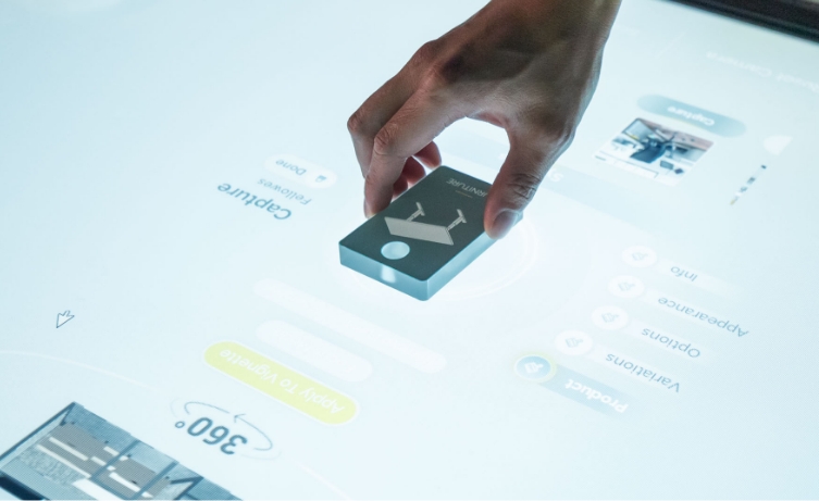 Image of a hand placing something down on a digital display table