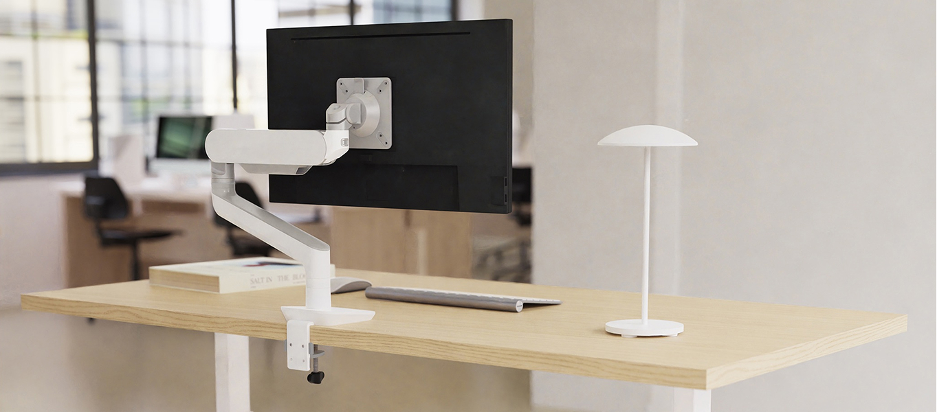 A Victory LX Table in an office space with a Rising Monitor Arm and a Glimor desk light