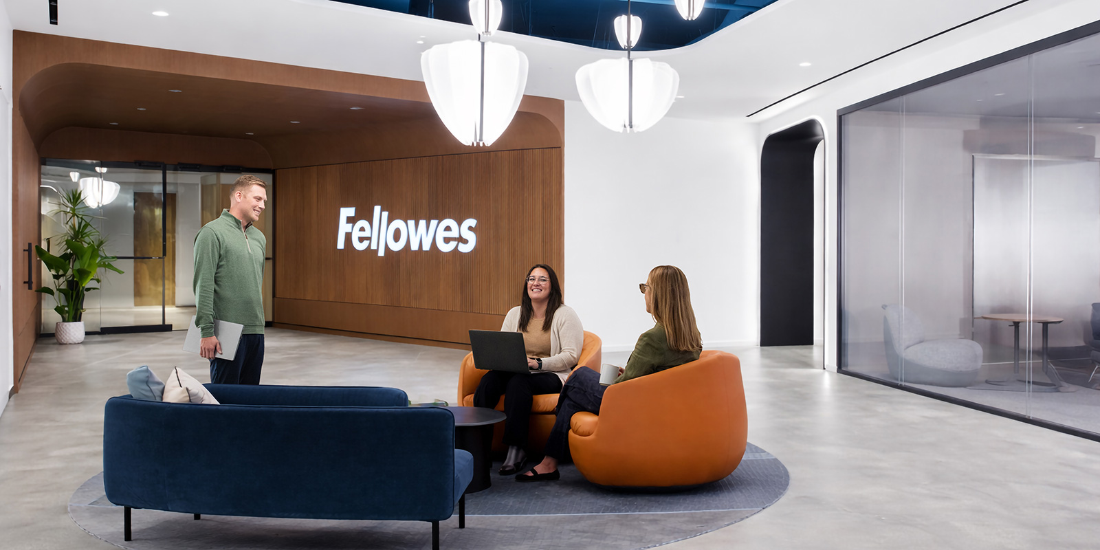 Image of people sitting in a lobby area of the Fellowes office building