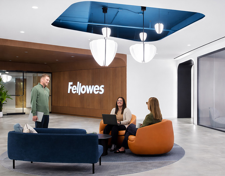 Image of people sitting in a lobby area of the Fellowes office building