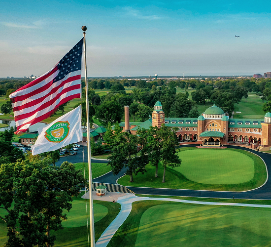 image of a beautiful country club building with the american flag in view
