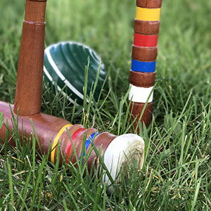 Image of croquet mallets and balls on the ground