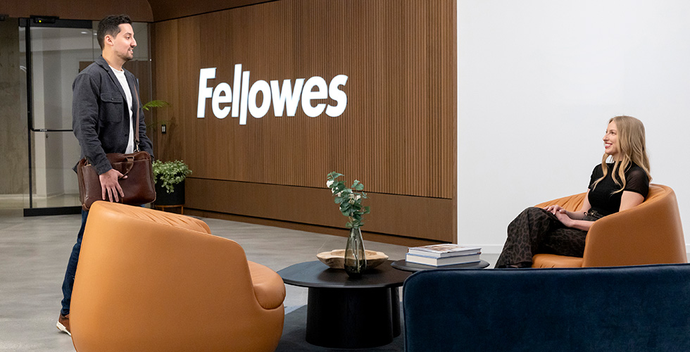 Image of a man talking to a sitting woman in a lobby area