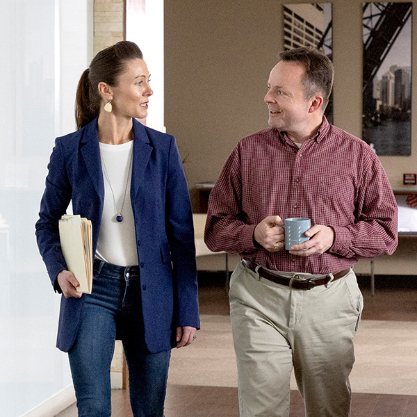 Image of a man and woman walking down a hallway