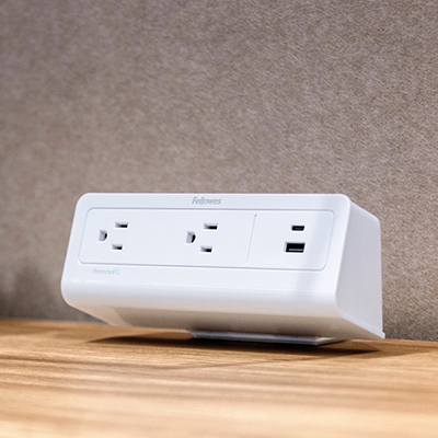 Image of a 3-plug power outlet on a desktop